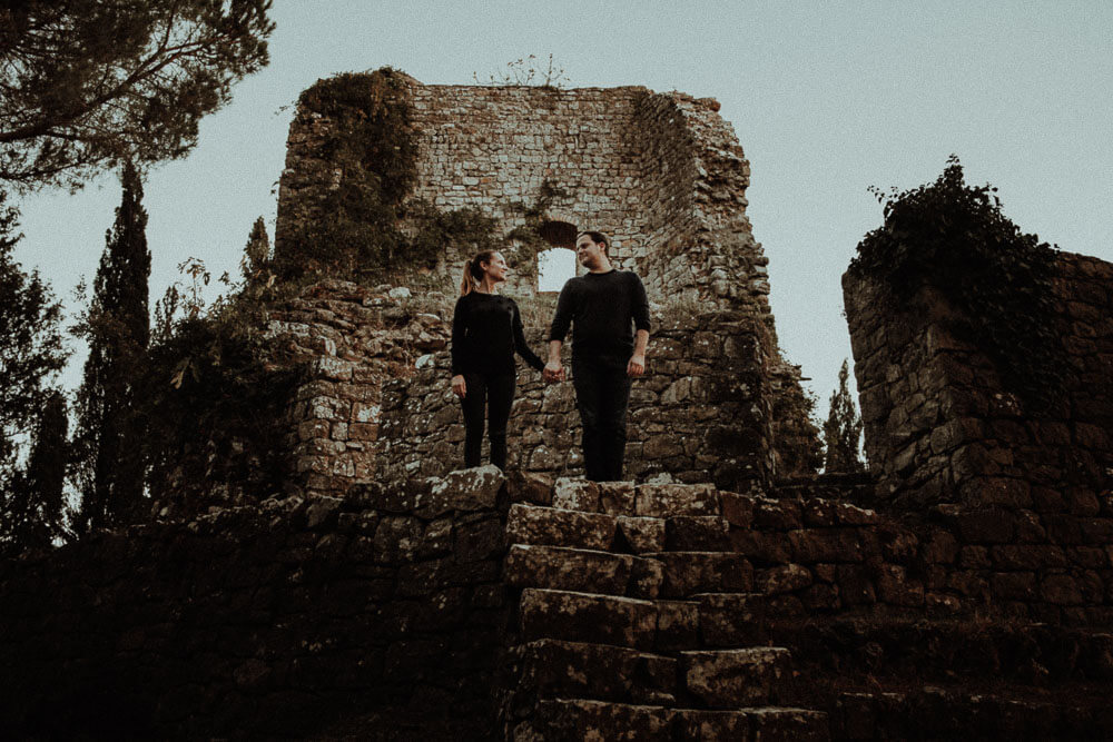Engaged couple portrait in ancient castle, in Val d'Orcia Tuscany