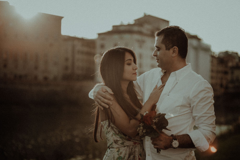 engaged couple photo at sunset on arno river in florence