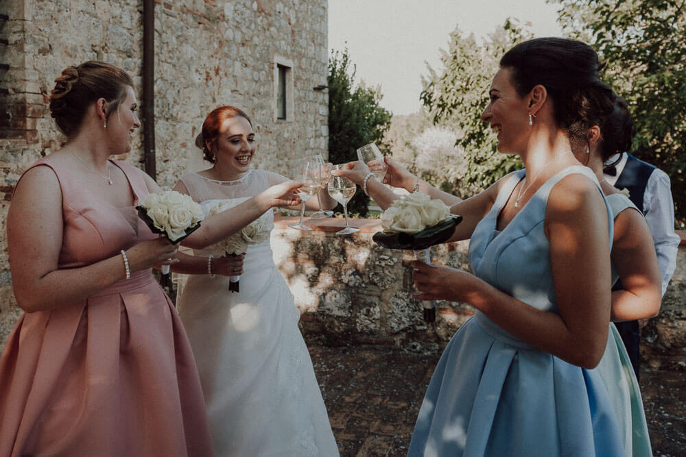 country wedding in tuscany, bride makes a toast with bridesmaids