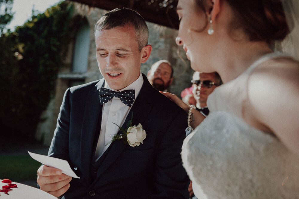 destination wedding in tuscany: groom read the wedding vows