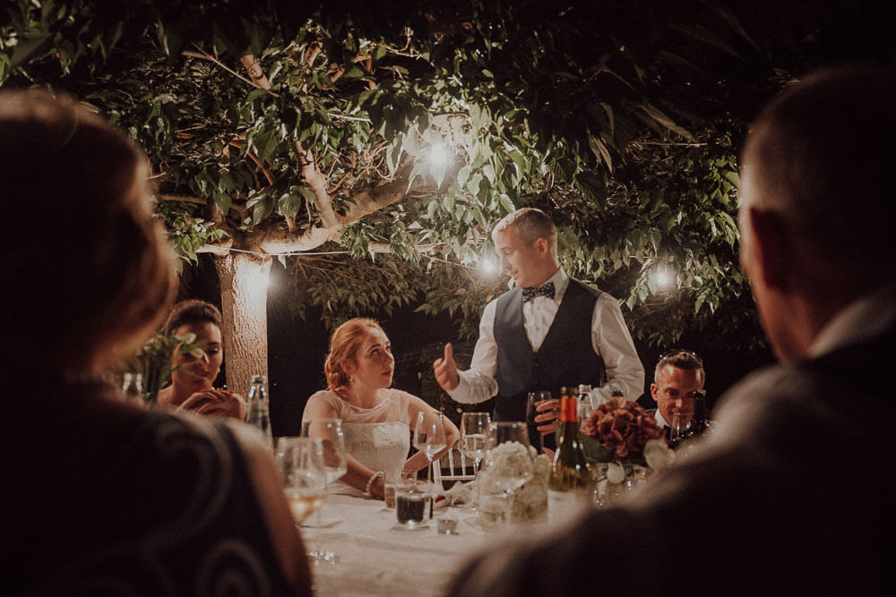 bride and groom speeches during irish wedding dinner in tuscany