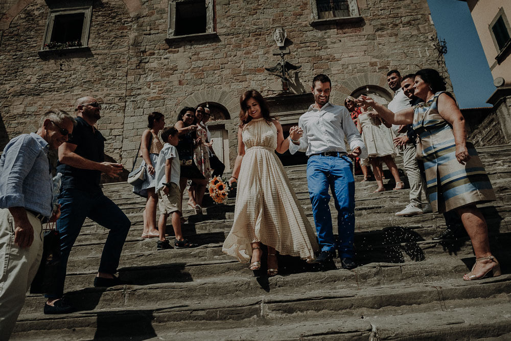 married couple walking down the steps of cortona town hall
