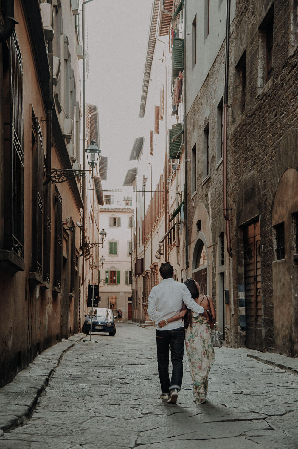 couple walking in piazza santa croce, engagement photography in florence